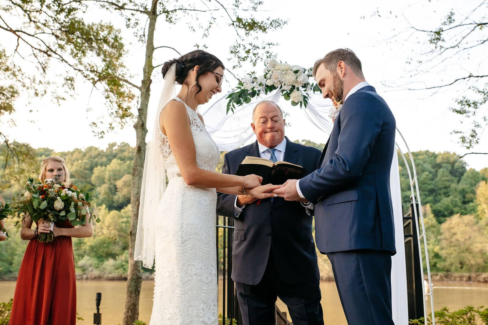 Bride and groom exchanging vows during an outdoor Georgia wedding ceremony with their officiant.