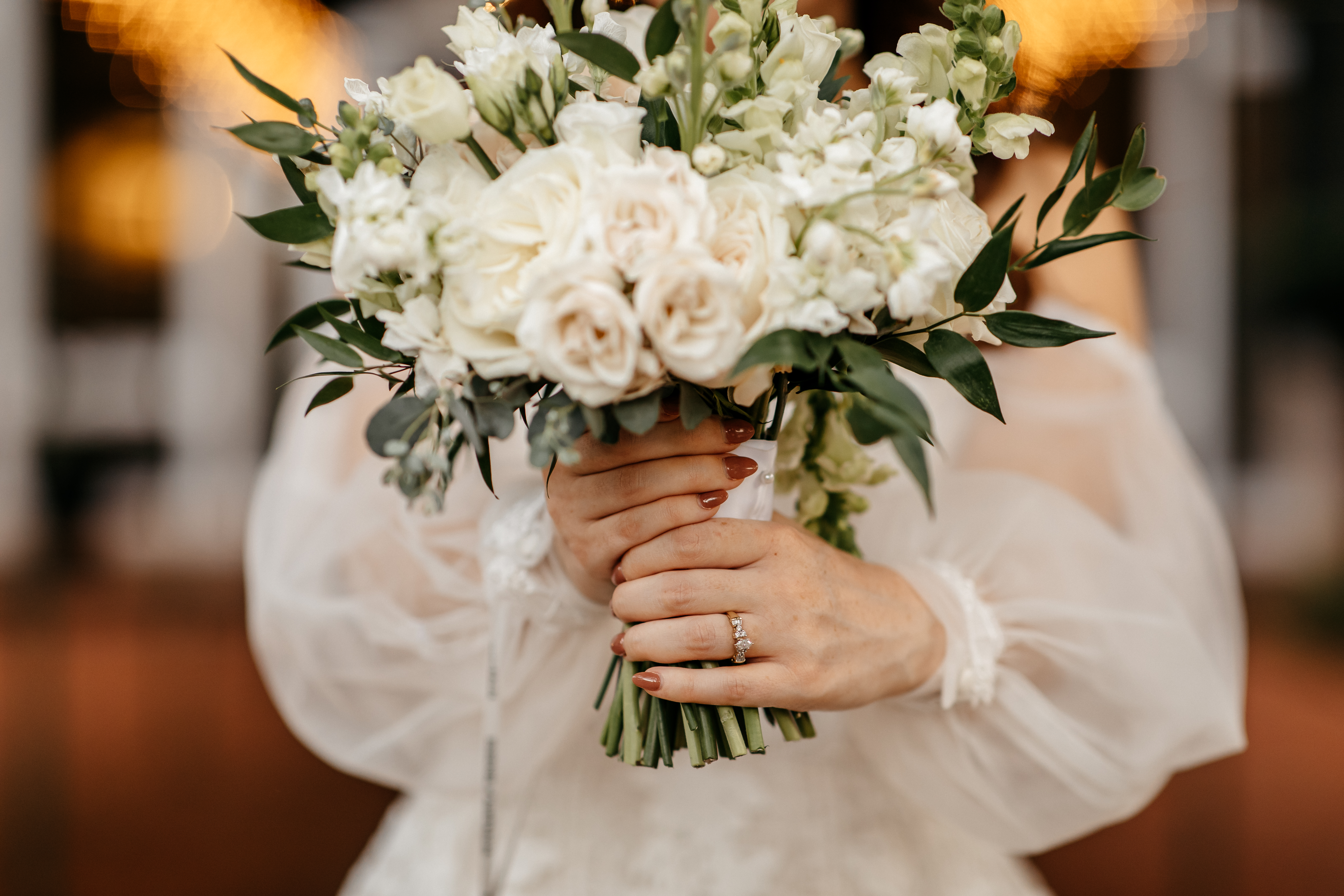 Bride holding a white wedding bouquet at one of the best wedding venues in Georgia.