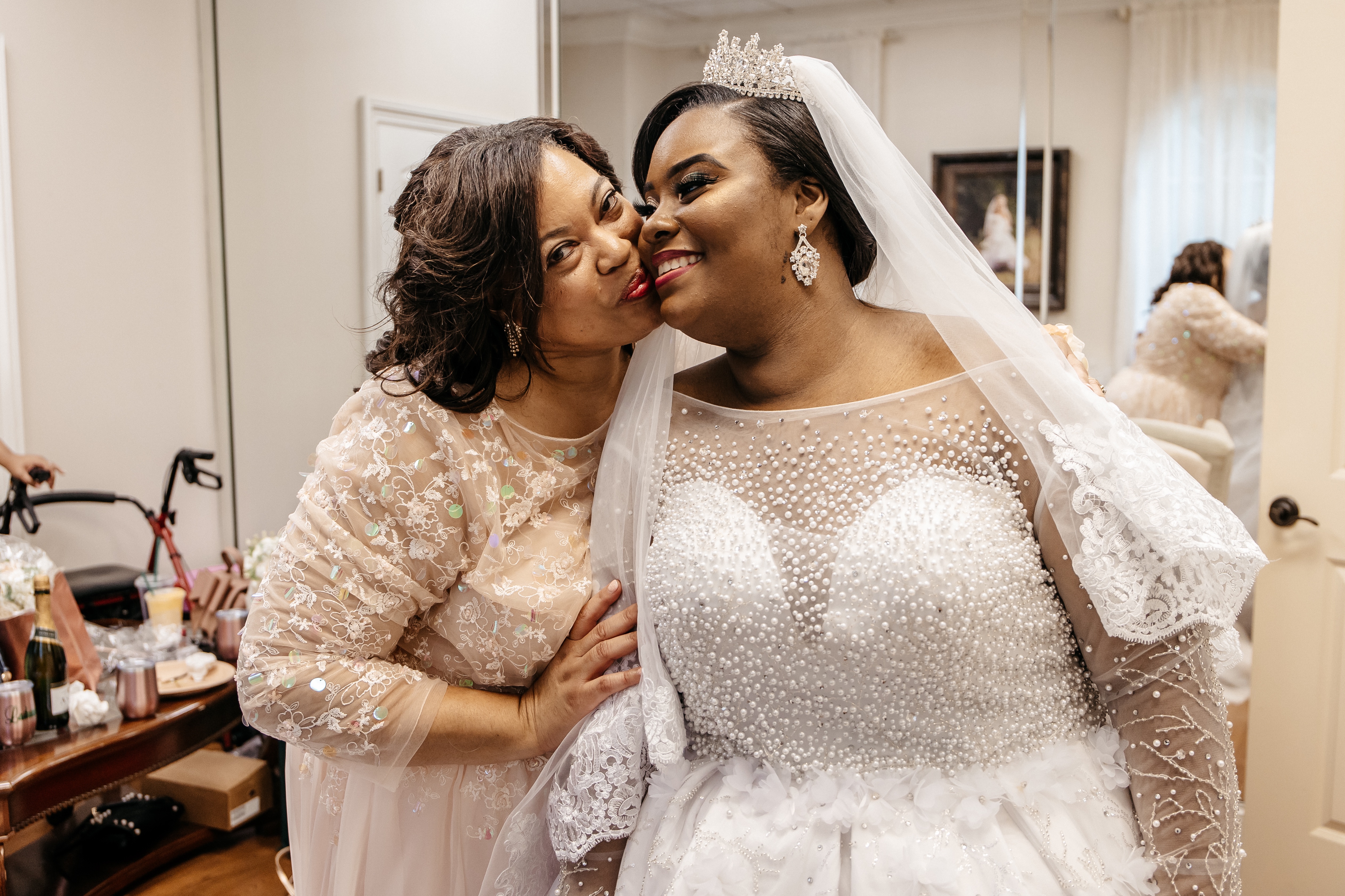 A bride receives a kiss from her mother after getting ready for her
micro wedding in north georgia