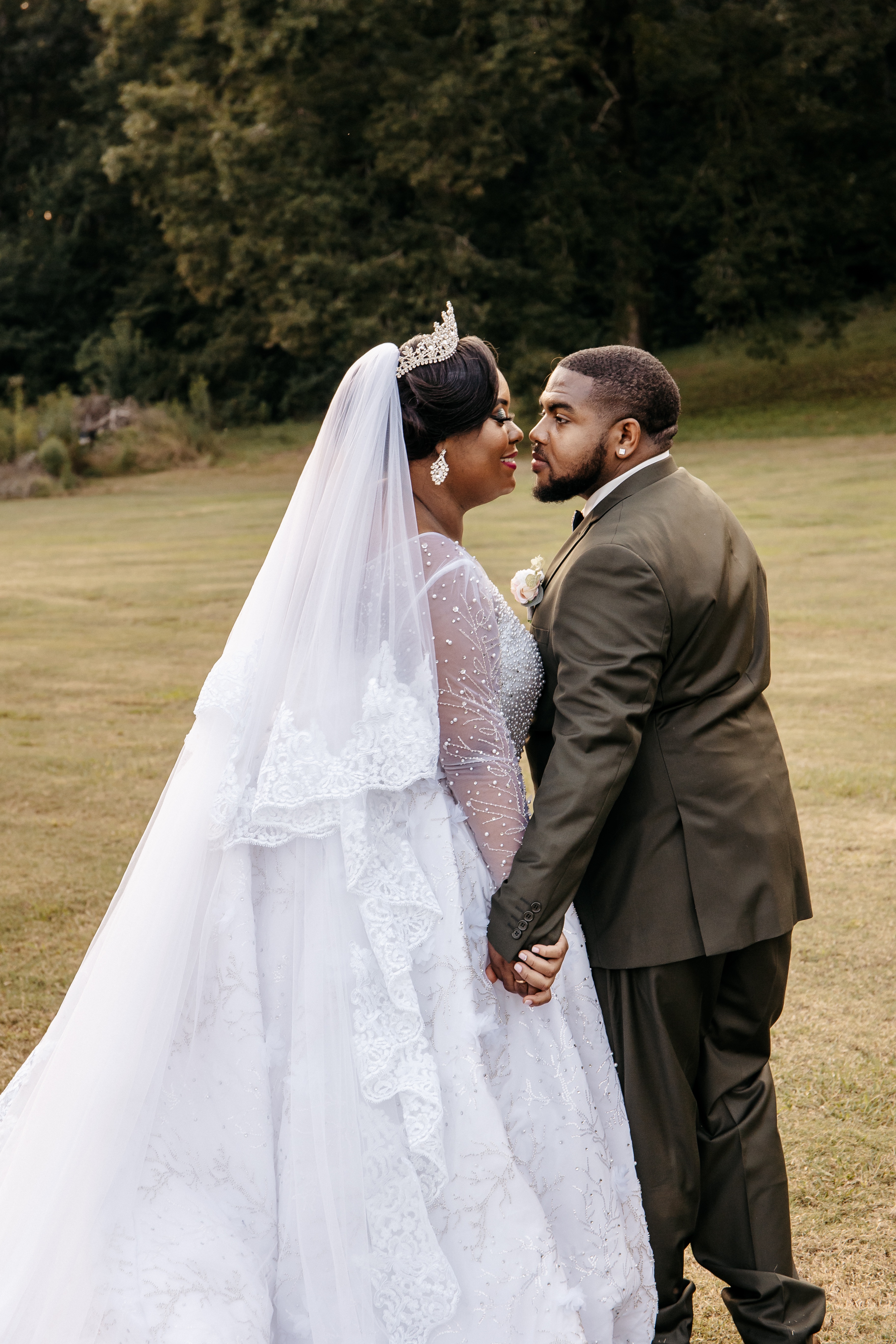A bride and groom stand in a field and kiss after their micro wedding ceremony in north georgia